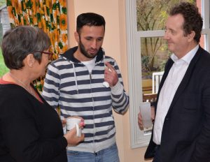 Sara Nathan, refugee G and council leader Julian Bell chatting at Sara's home