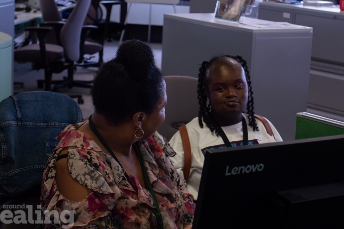 2 adult women sitting and talking