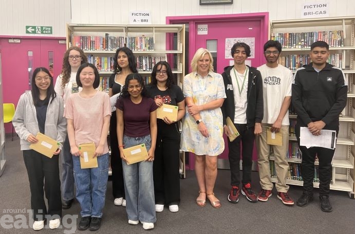 Group of people smiling - students with A-level results and a councillor