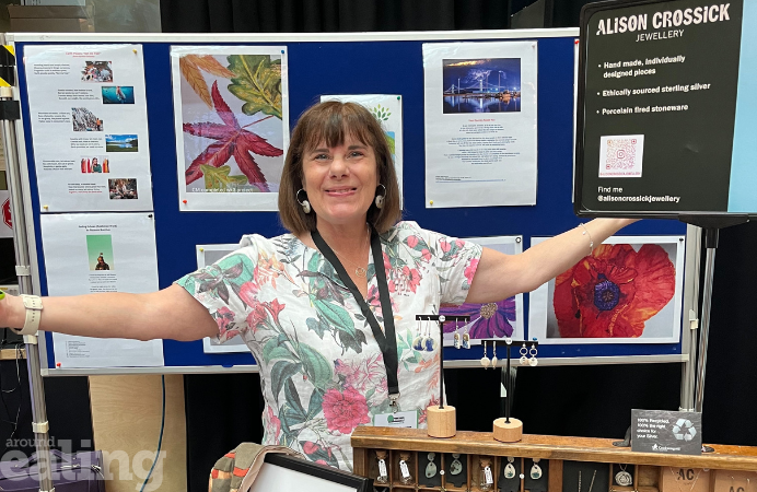 Woman poses for a photo in front of jewellery stand