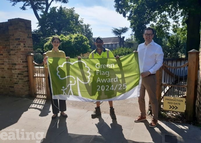 Councillor Peter Mason and councillor Blerina Hahani with a Park ranger holding up a Green flag award 24/25 flag.