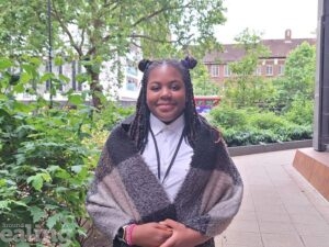 teenage girl standing smiling outside Perceval House