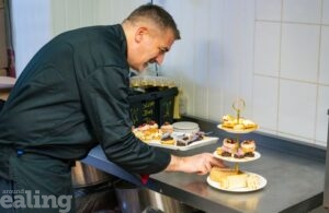 Chef placing food on a cake stand