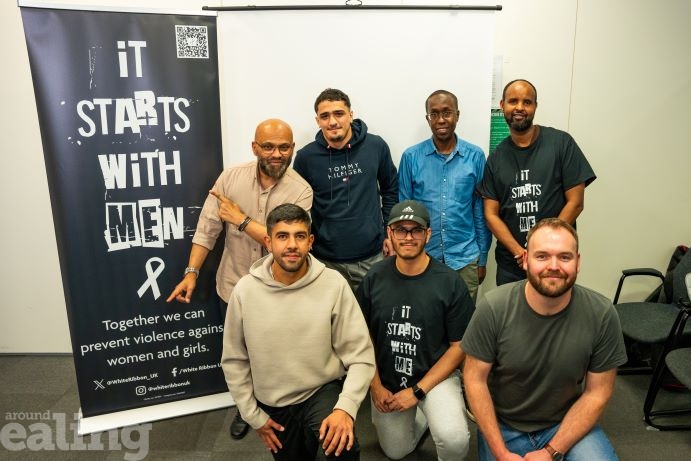 Group of men stand together in support of White Ribbon Day campaign