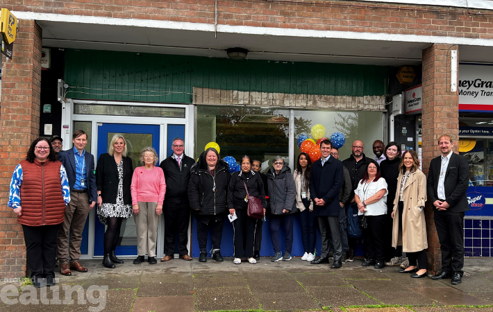 Group of men and women in coats stood outside Havelock community office, posing for a photo to celebrate the opening of community offices at Havelock estate