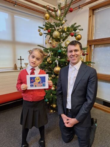 Ealing Council Chief Executive Tony Clements with Christmas card 6 years and under winner Imogen.