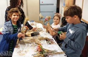 Children sitting around a table doing arts and crafts