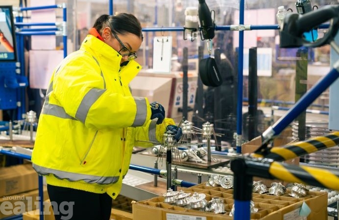 Anna wearing hi-vis jacket, making bike wheel