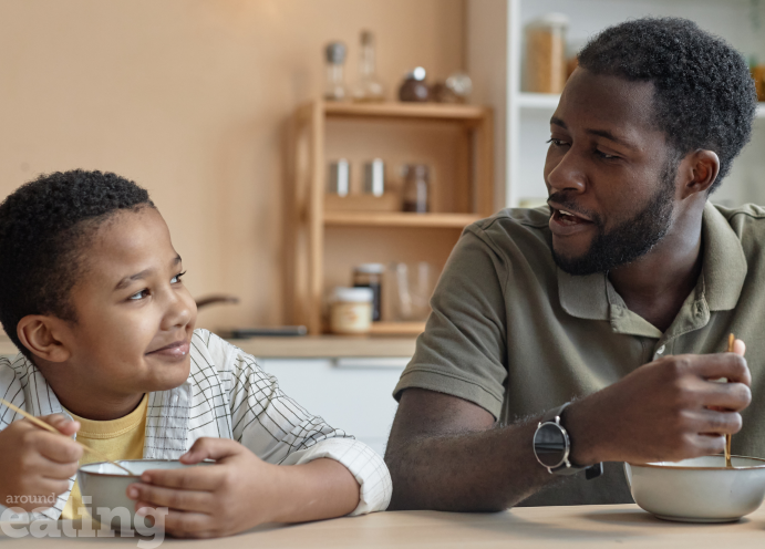 Man and boy eating breakfast together