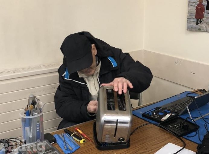 Man repairing toaster